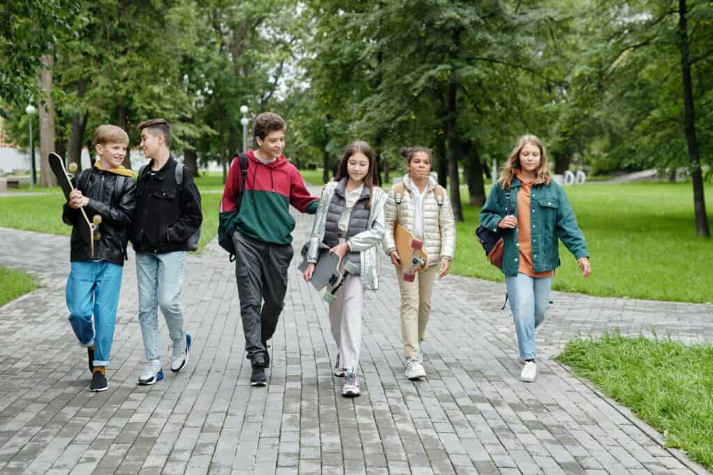 Children walking together with their longboards